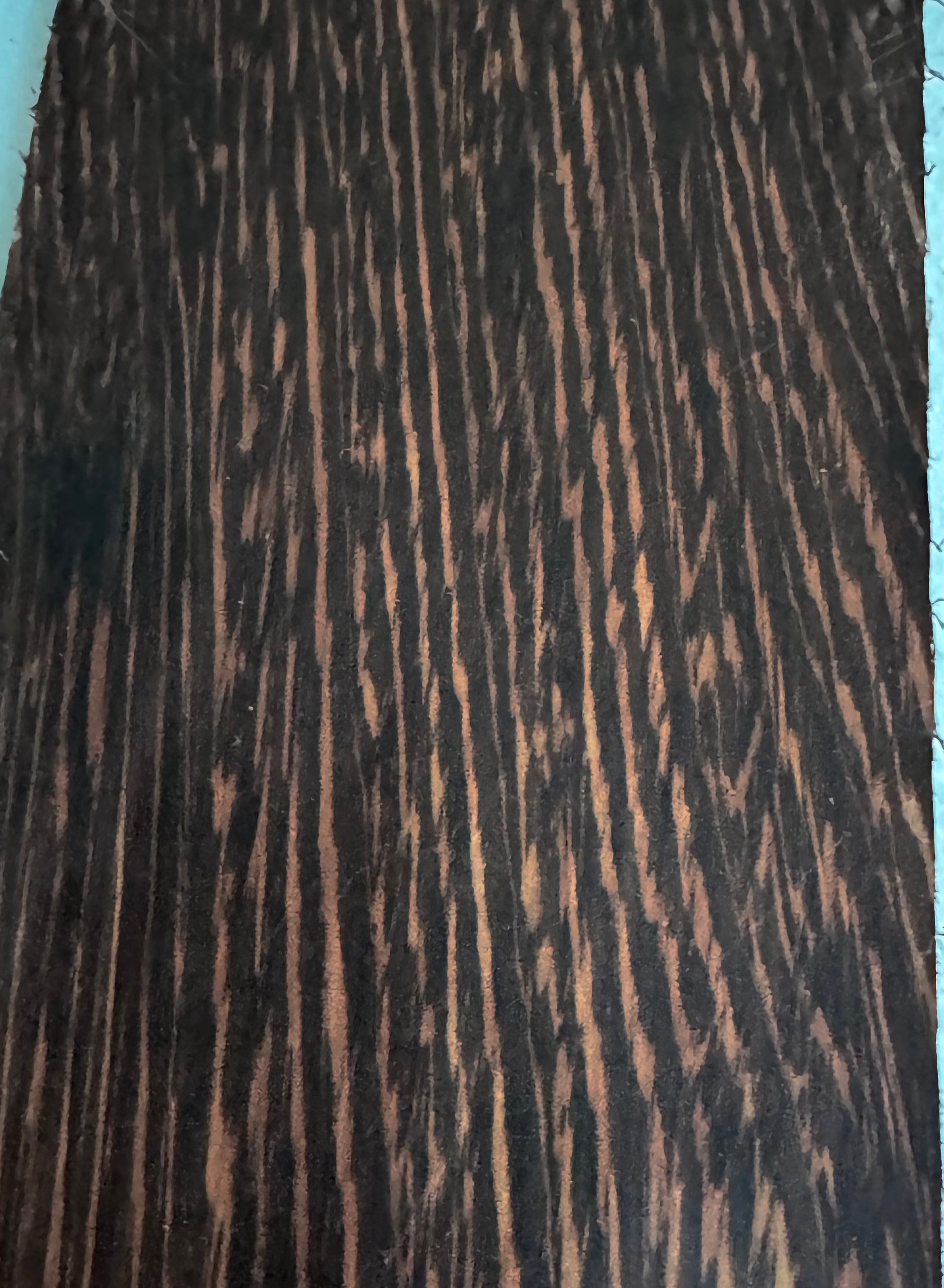 Heartwood is medium brown, sometimes with a reddish or yellowish hue, with nearly black streaks. Upon application of a wood finish (particularly an oil finish) the wood can become nearly black.